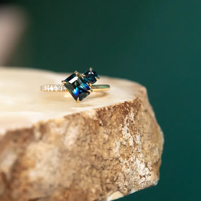 Anueva Jewelry Rings 132ct Askew Emerald Cut Parti Sapphire and 031ct Round Sapphire Ring with asymmetrical diamonds in 18k Yellow Gold